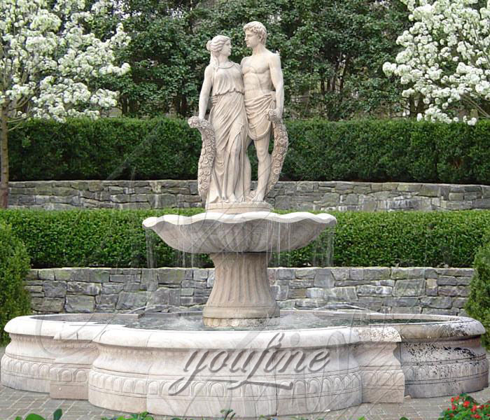 Outdoor natural marble water fountains with young lovers hold flowers for garden