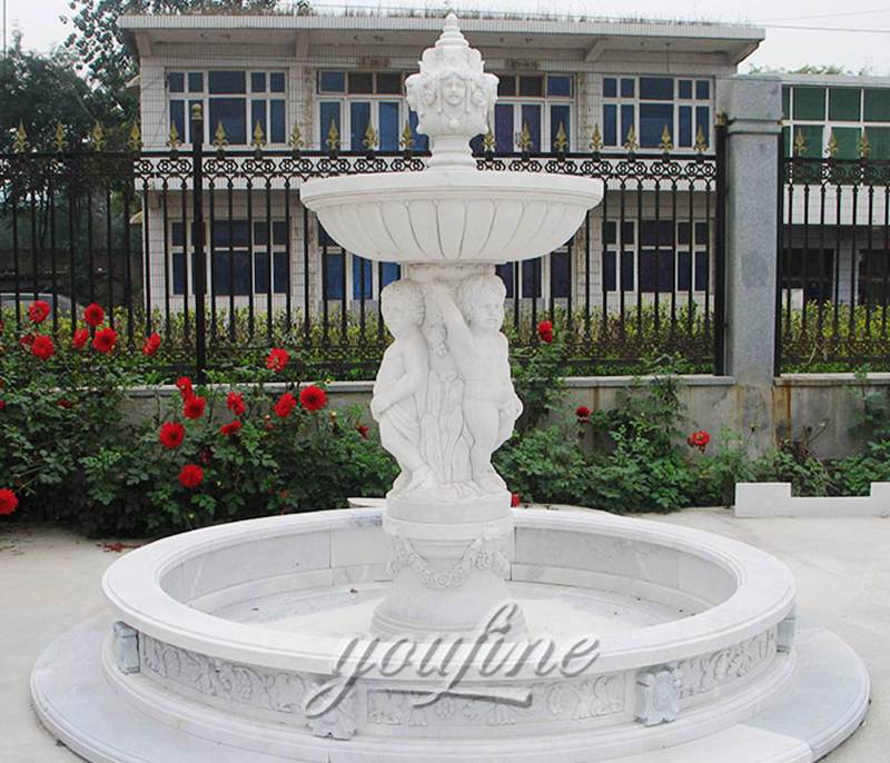 Large outdoor tiered marble water fountain with cherub statue for hotel decor